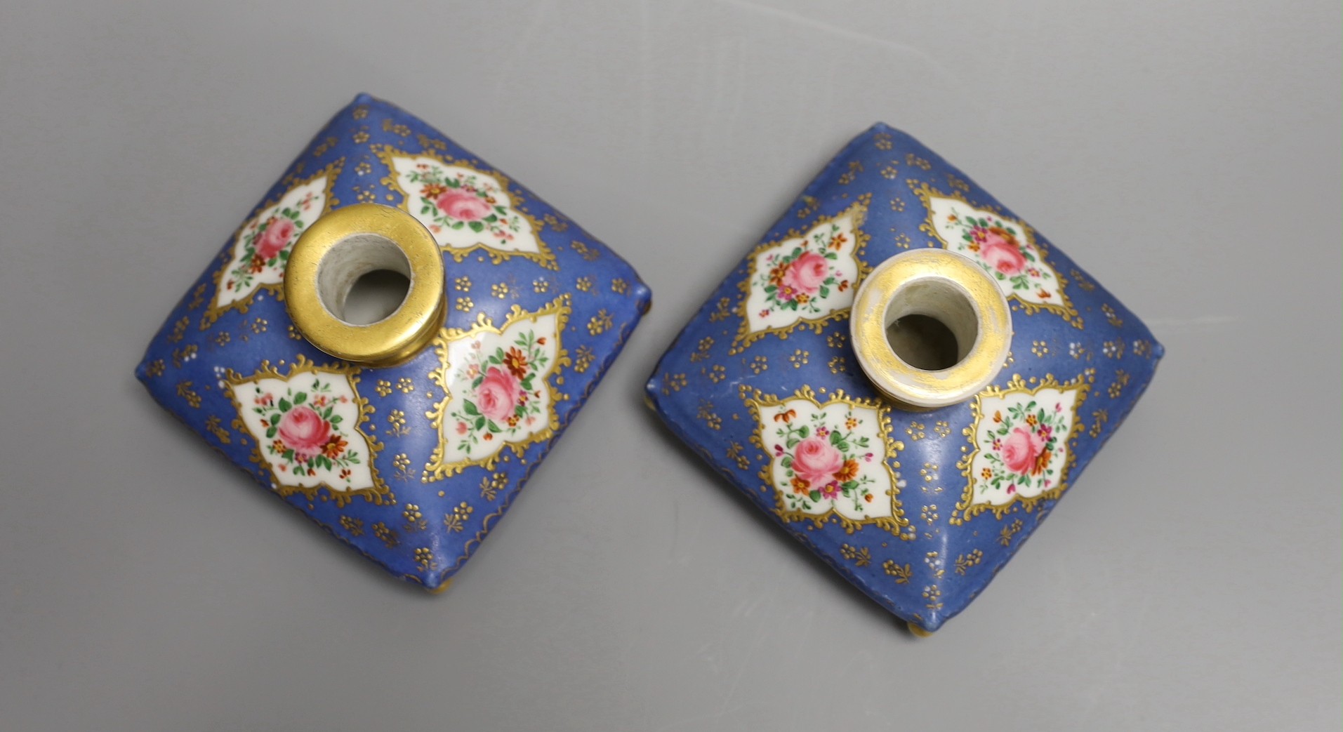 A pair of mid 19th century Paris porcelain 'cushion' shaped scent bottles decorated in Sevres style with pink roses (lacking stoppers)